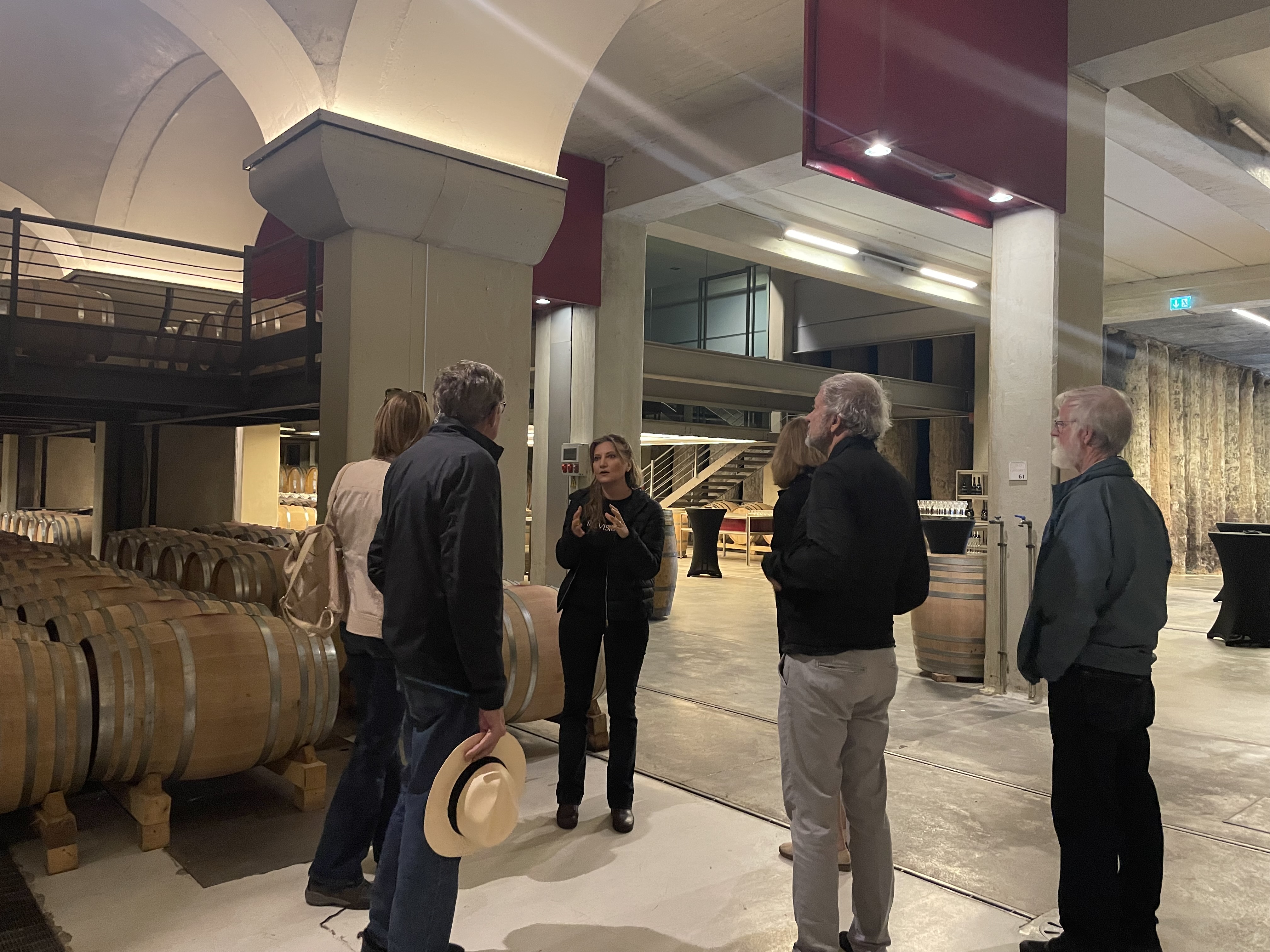 Campania winery interior with barrels, wine tour group